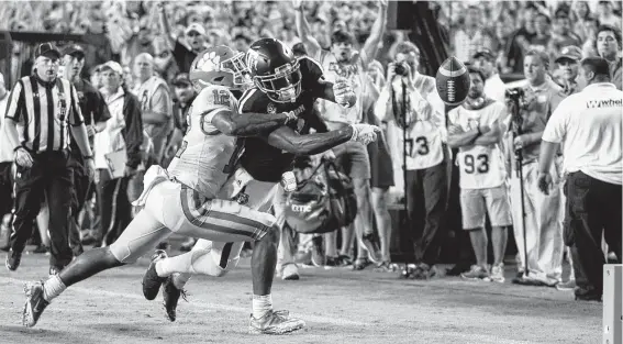  ?? Sam Craft / Associated Press ?? Texas A&amp;M receiver Quartney Davis, right, has the ball punched out of his hands by Clemson’s K’Von Wallace for a crucial touchback late in the fourth quarter.