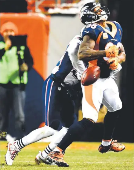  ?? John Leyba, The Denver Post ?? New England Patriots safety Devin McCourty breaks up a fourth-down pass intended for Broncos wide receiver Demaryius Thomas during the fourth quarter Sunday. The fierce hit essentiall­y ended the Broncos’ comeback hopes.