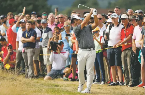  ?? PETER MORRISON/ASSOCIATED PRESS ?? Francesco Molinari of Italy plays a shot on the 12th hole during the final round of the British Open on Sunday in Carnoustie, Scotland. Molinari gave Italy its first victory in a major Sunday by outplaying a tightly packed field that included defending champion Jordan Spieth, a resurgent Tiger Woods, Justin Rose and Rory McIlroy.