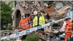  ??  ?? Emergency workers examine the wreckage