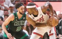  ?? JOHN MCCALL/SOUTH FLORIDA SUN SENTINEL ?? Heat forward Jimmy Butler is defended by Celtics guard Derrick White during the first half of Game 3 of the Eastern Conference finals Sunday in Miami.