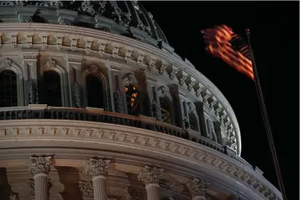  ?? Associated Press ?? ■ An American flag flutters in the wind Tuesday in front of the U.S. Capitol dome in Washington.