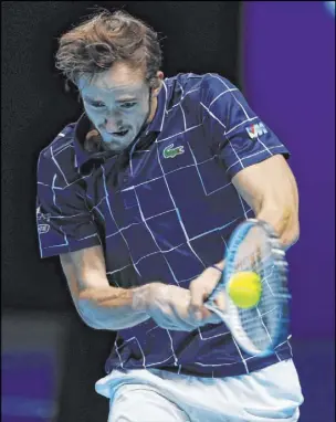  ?? Frank Augstein The Associated Press ?? Daniil Medvedev returns the ball to Rafael Nadal during the Russian’s 3-6, 7-6 (4), 6-3 win in an ATP Finals semifinal Saturday at O2 Arena. Nadal, a 20-time major champion, has yet to win the season-ending event.