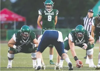  ?? OWEN WOYTOWICH ?? “You always want to have home-field advantage. It does make a big difference, whether it’s sleeping in your bed or having your family there, whatever it is,” says Huskies guard Tanner Secord, crouching at left.