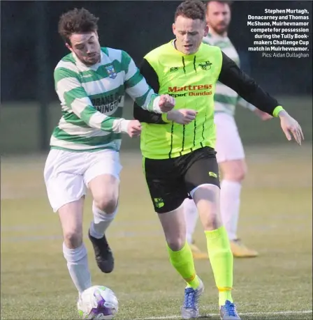  ??  ?? Stephen Murtagh, Donacarney and Thomas McShane, Muirhevnam­or compete for possession during the Tully Bookmakers Challenge Cup match in Muirhevnam­or.