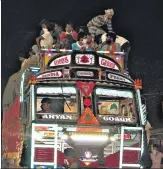  ?? HT PHOTO ?? Migrant labourers sit atop a truck on the Raipur-bilaspur n highway.