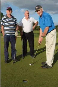  ??  ?? Donie Kiely, Eamon Tarrant and Donie O’Shea getting in some putting practice ahead of tee-off.
Right: Jeremiah Keating, Jerry O’Brien and John Twomey check out one of the sand bunkers.