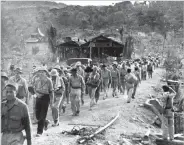  ?? AP FILE PHOTO ?? American and Filipino prisoners of war captured by the Japanese are shown at the start of the Death March after the surrender of Bataan on April 9, 1942, near Mariveles in the Philippine­s.