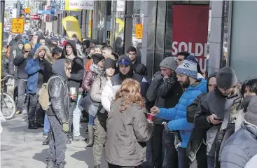  ?? RYAN REMIORZ / THE CANADIAN PRESS ?? Customers line up at a government cannabis store in Montreal on Thursday, as a surge of interest across the country led to shortages of certain strains of marijuana.