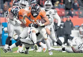  ?? DENVER POST FILE ?? Broncos running back Phillip Lindsay finds a hole against the Oakland Raiders last season.