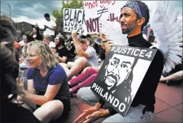  ?? Richard Tsong-taatarii ?? The Associated Press Protesters gathered Sunday at Silver Lake Village Shopping Center in St. Anthony, Minn., to express anger over the acquittal of Officer Jeronimo Yanez, was found not guilty of manslaught­er for shooting Philando Castile during a...