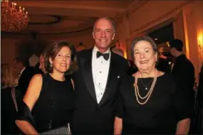  ??  ?? When the dinner bell rings Jay Devine of Strafford escorts his wife, Bridget, and Mary Duden to their table.