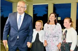  ?? — AFP ?? Australia’s incoming Prime Minister Scott Morrison with his wife Jenny Morrison and daughters Abbey and Lily at the oath- taking ceremony in Canberra on Friday.