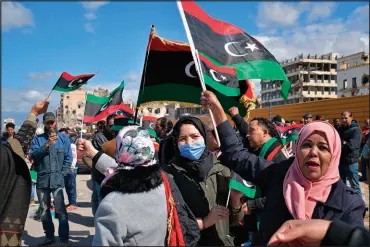  ?? HAKEAM EL-YAMANY / ASSOCIATED PRESS ?? Libyans on Feb. 17 mark the 10th anniversar­y of their 2011 uprising that led to the overthrow and killing of longtime ruler Moammar Gadhafi, in Benghazi, Libya. An interim government has been appointed in order to prepare the divided country for elections scheduled on Dec. 24.