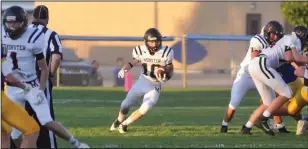  ?? Staff photo/Mike Zwez ?? Connor Shmiesing carries the ball and looks to turn up field Friday night in a MAC game against Marion Local.