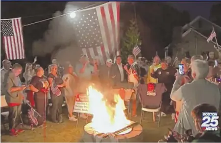  ?? PHOTO COURTESY BOSTON 25 NEWS ?? FIRED UP: A huge crowd gathers Thursday night in Mark Shane’s yard in Swansea to burn Patriots jerseys and T-shirts in response to players taking a knee during the national anthem on Sunday at Gillette Stadium.