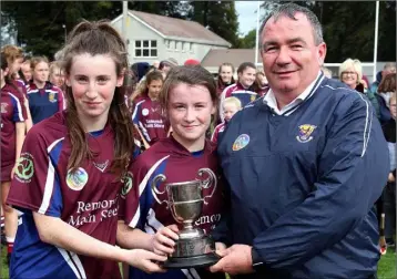  ??  ?? The Kelly twins, Yvonne and Lisa, joint captains of Bunclody, accepting the trophy from Donnacha Kerins (Co. Chairman) in Farmleigh on Sunday.