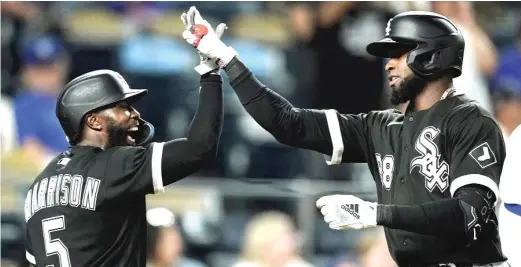  ?? CHARLIE RIEDEL/AP ?? Luis Robert (right) celebrates with Josh Harrison after hitting a two-run home run in the 10th inning Monday night against the Royals.