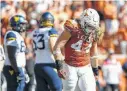  ?? Tim Warner / Getty Images ?? End Breckyn Hager, right, is expected to take the field today in Lubbock for a struggling Texas defense despite being on the mend from a dislocated radius.