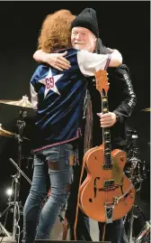  ?? EUGENE HOSHIKO/AP ?? Randy Bachman, right, and Takeshi embrace after Bachman was reunited with his stolen Gretsch guitar Friday at the Canadian Embassy in Tokyo.