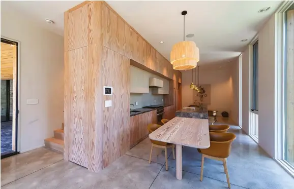  ??  ?? BELOW: The interiors, curated by Partisans and John Baker of Mjölk, emphasize rounded edges. The Douglas fir–clad kitchen features a matching wood and marble table–island unit complement­ed by &Tradition’s Elefy dining chairs.