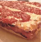  ?? CAROL DEPTOLLA/MILWAUKEE JOURNAL SENTINEL ?? Detroit-style pizza’s square pies call for brick cheese or a brick blend spread to the edges of the pan, where the cheese browns. Sauce is applied on top.