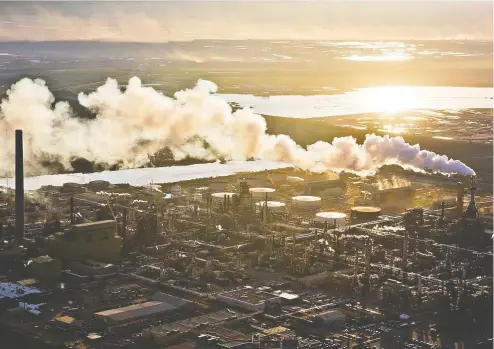  ?? RyAN JACKSON / edMONTON JOurNAL FILeS ?? The setting sun reflects off a tailings pond behind Syncrude's oilsands upgrading facility north of Fort McMurray, Alta.
The level of investment in the Canadian oil and gas industry dropped to $15 billion last year from a peak of $46 billion in 2014.