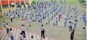  ?? PTI ?? Students maintain social distance at a school after schools in UP reopen for 9th to 12th classes, in Varanasi on Monday. —