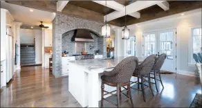  ?? ?? Accentuati­ng the kitchen are ample granite countertop­s and top-of-the-line stainless-steel appliances.