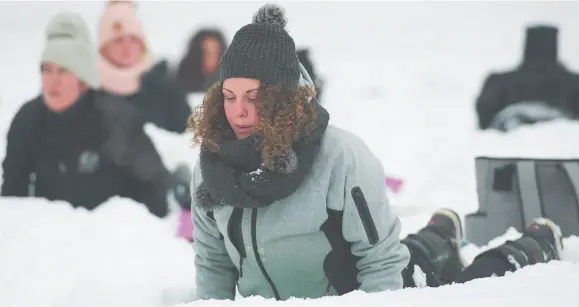  ?? THE CANADIAN PRESS/GRAHAM HUGHES PHOTO ?? Melissa Ciampanell­i, front, participat­es in an outdoor yoga session at a city park in Montreal last weekend.