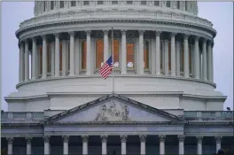  ?? PABLO MARTINEZ — THE ASSOCIATED PRESS ?? An American flag flies at half-staff Saturday at the Capitol in Washington. President Joe Biden ordered the move to mark 1million American lives lost due to COVID-19.