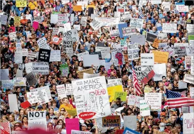  ?? STEVE SCHAEFER / SPECIAL TO THE AJC ?? Part of a crowd estimated at 30,000 people fills the streets of Atlanta on Saturday during the March For Our Lives rally to protest gun violence such as the Feb. 14 massacre at a high school in Parkland, Fla.