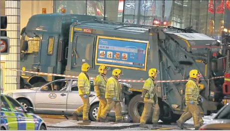  ??  ?? CARNAGE: Emergency personnel at Glasgow’s George Square, the scene of December’s bin lorry crash which claimed the lives of six people.