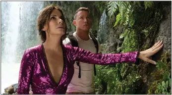  ?? (Kimberley French/Paramount Pictures via AP) ?? Sandra Bullock (left) and Channing Tatum appear in a scene from “The Lost City.”