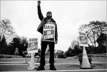  ?? ASSOCIATED PRESS ?? RYAN PIPER WITH THE UNITED AUTO WORKERS continues to picket after news of a tentative contract agreement with General Motors, in Langhorne, Pa., Wednesday, Oct. 16. Bargainers for General Motors and the United Auto Workers reached a tentative contract deal on Wednesday.