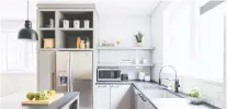  ??  ?? White subway tiles were installed right up to the ceiling in this N.D.G. kitchen for an industrial look. And open storage (below) can make a kitchen feel similar to a coffee shop, with everything easily accessible.