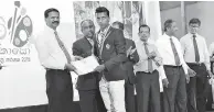  ??  ?? Category (vi) national first place winner receive the award from Education Ministry Additional Secretary R.M.M. Rathnayake