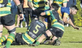  ?? PHOTO: GERARD O’BRIEN ?? Coming through . . . Taieri’s TeKorohi Rupene crashes through the Green Island defence to score during a Dunedin premier club rugby match at Miller Park last month.