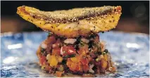  ??  ?? The seared trout, served on a tomato salsa, is perfectly cooked.