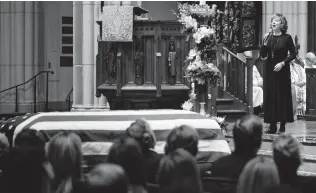  ?? David J. Phillip / Getty Images ?? Reba McEntire sings “The Lord’s Prayer” during a funeral service for former President George H.W. Bush on Thursday in Houston. As with Sen. John McCain, Bush’s passing brought out tribalism in some quarters.