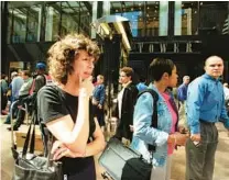  ?? HEATHER STONE/CHICAGO TRIBUNE ?? Jan Stephens, a paralegal at Latham & Watkins, in front of the Sears Tower after it was evacuated on Sept. 20, 2001. The tower was evacuated after a rumor spread that a hijacked airplane was headed for Chicago.