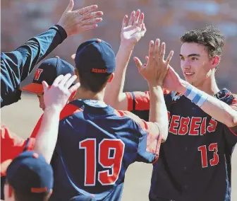  ?? STAFF PHOTO BY MATT WEST ?? ROCKING REBELS: Jack Magane gets high fives from Walpole teammates after scoring during yesterday’s Super Eight victory against St. John’s Prep.