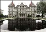  ?? HANS PENNINK — THE ASSOCIATED PRESS ?? This is a view of the New York state Capitol Wednesday in Albany, N.Y. Legal marijuana, new rights for farmworker­s and a stronger legal standard for sexual harassment were among the final issues debated by New York state lawmakers Wednesday, the day they are scheduled to adjourn their 2019 session.