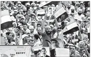  ??  ?? Supporters of deposed Egyptian president Mohamed Morsi hold portraits of him and national flags during a rally on July 9, 2013 outside Cairo's Rabaa al-Adawiya mosque -AFP