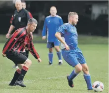  ??  ?? Pennywell Vets (blue) defend against Over-40s rivals Pennywell Coms