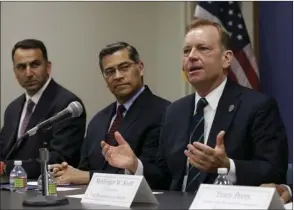  ?? AP PHOTO/RICH PEDRONCELL­I ?? McGregor Scott (right) the United States Attorney for the Eastern District of California, flanked by California Attorney General Xavier Becerra (center) discusses an increase in the use of a banned pesticide at illegal marijuana farms hidden on public...