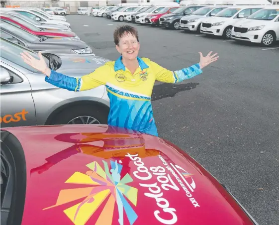  ?? Picture: MIKE BATTERHAM ?? Commonweal­th Games volunteer Jane Buckley with the fleet of cars needed for the event.