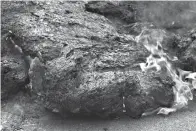  ?? Associated Press ?? ■ In this May 5 file photo, lava burns across a road in the Leilani Estates subdivisio­n near Pahoa, Hawaii. The lava hisses, crackles and pops. It roars like an engine as it sloshes and bubbles. It shoots into the sky, bright orange and full of danger,...