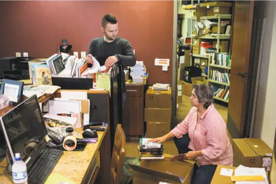  ?? Photos by James Tensuan / Special to The Chronicle ?? Laurel Book Store owner Luan Stauss (right) and Joseph Luadick organize book orders at the store in Oakland’s historic flatiron building.