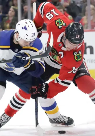  ?? | NAM Y. HUH/ AP ?? The Hawks’ Jonathan Toews and the Blues’ Vladimir Sobotka battle for the puck Sunday.